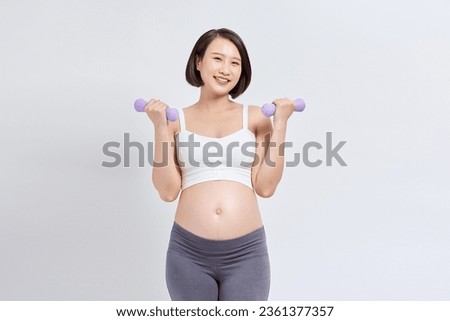 Happy young pregnant woman do exercise isolated on white background