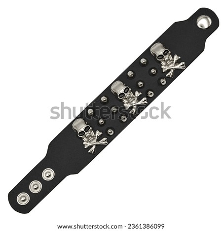 Black leather bracelet with spikes, skulls and bones. jolly roger Pirate Style, filibuste. An accessory for rockers, bikers, metalheads, goths and punks. Steampunk style. Close-up subject photography.