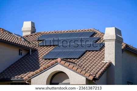 Solar panels on rooftop in California. Royalty-Free Stock Photo #2361387213