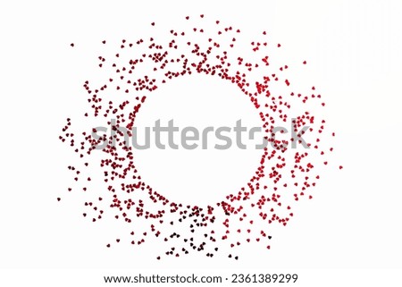 Valentine's Day background - a circular frame of scattered heart shaped confetti over white background.
