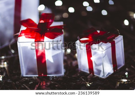 Glowing Christmas gifts under tree