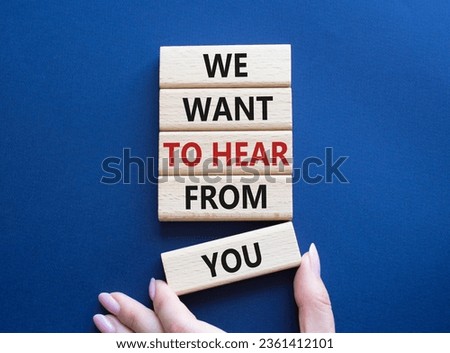 We want to hear from you symbol. Wooden blocks with words We want to hear from you. Beautiful deep blue background. Businessman hand. Business and We want to hear from you. Copy space.