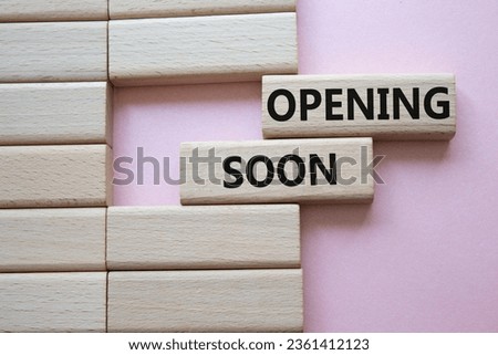 Opening soon symbol. Concept word Opening soon on wooden blocks. Beautiful pink background. Business and Opening soon concept. Copy space