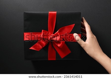The concept of black friday, a gift in a black wrapper.