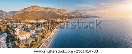captivating charm of Kemer's landscape through stunning aerial photo, where hotels, a beautiful sea beach, and majestic mountains converge to create an idyllic panorama. Royalty-Free Stock Photo #2361414783