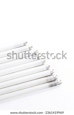 Line of Used Obsolete Fluorescence Lamps Placed on Pure White. Vertical image
