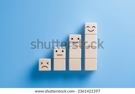 Business growth steps, wooden cube stacked with sad to happy emotions. Service or prodcut satisfaction, evaluation, customer review, rating survey concept. Emotional state and mental health day. Royalty-Free Stock Photo #2361421597