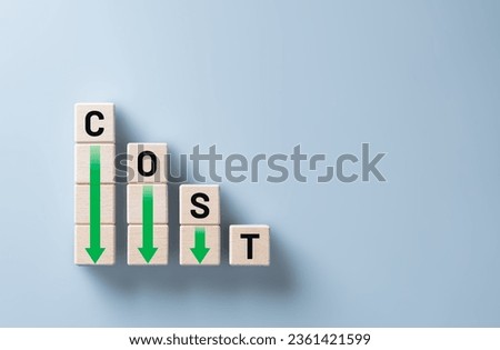 Lean and Cost reduction concept. Decreasing company expenses to maximize profits. Stacked wooden cube with word cost and green down arrows. Business improvement, manufacturing optimization management. Royalty-Free Stock Photo #2361421599