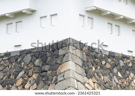 Close-up of white and stone wall of Japanese castle