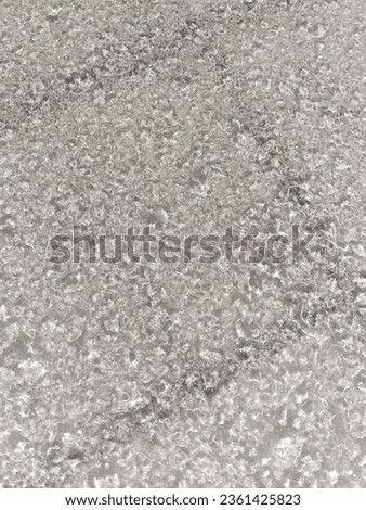 Photograph of white dust and water stains on a black car behind.