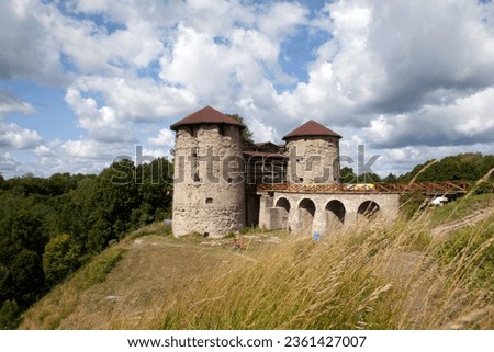 A picturesque view of the southern and northern towers of the Koporye fortress, the fortress bridge on a high rock, on the edge of the Izhora Upland. The village of Koporye. Leningrad region. Russia Royalty-Free Stock Photo #2361427007