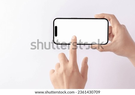 Hand holding a new smartphone on a white background.