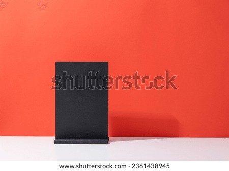 Mock up of blank menu frame, Stand for booklets with white sheets paper on red background with copy space
