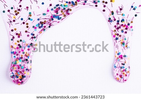 Colorful glitter sparkle confetti background liquid drops of paint color flow down on white canvas. Dark multicolored glitter paint dripping on the white wall