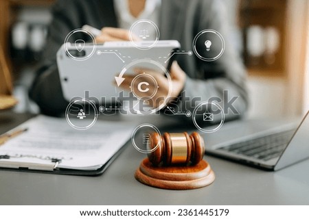 Copyright or patent concept, Person hand using laptop computer, tablet and smartphone with virtual screen copyright icon trademark, Creation ownership against piracy. at office


