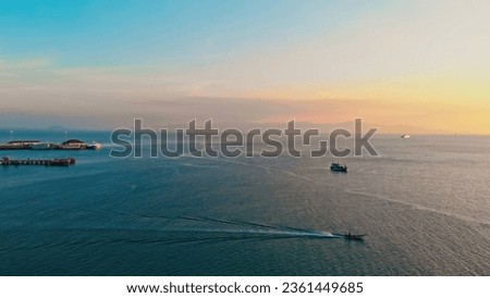 Approaching shot of mesmerizing seascape, pier and islands at sunset. Aerial view of sailing boats and gentle bewitching seascape in Caribbean sea. Concept recreation mindset and enjoying seascape. 