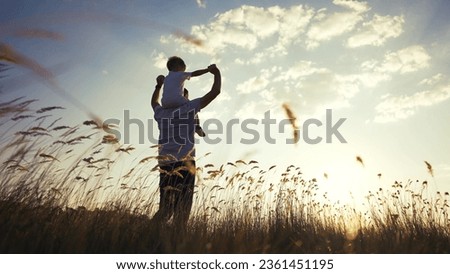 father and son in the park. father day silhouette happy family child dream concept. father carries his son on his back. dad playing with his son in nature in the park silhouette at sunset lifestyle Royalty-Free Stock Photo #2361451195