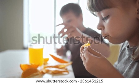 children eat oranges. happy family kid dream concept. drinking fresh juices. lifestyle morning breakfast brother and sister eat oranges in the kitchen. fruits orange juice healthy eating
