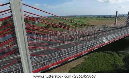 Aerial of Modern Highway Cable-Stayed Bridge on River Royalty-Free Stock Photo #2361453869