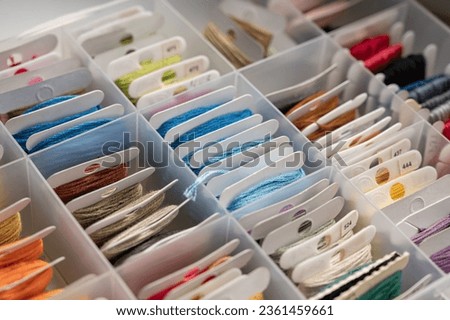 Plastic storage box for floss. Threads on the spool. Different colors. Cotton floss for embroidery and needlework Royalty-Free Stock Photo #2361459661