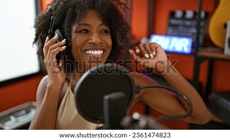 African american woman radio reporter wearing headphones speaking at radio studio