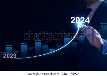 Businessman analysis profitability of working companies with digital augmented reality graphics, positive indicators in 2024, businessman calculates financial data for long term investments Royalty-Free Stock Photo #2361475923