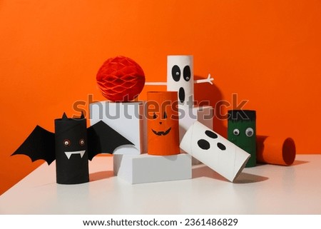 Paper halloween mockups on table on orange background