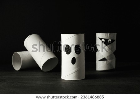 Paper mockups of ghosts and mummies on the table on black background