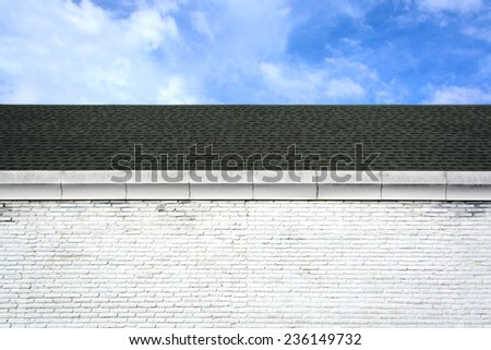 roof and brick wall with blue sky
