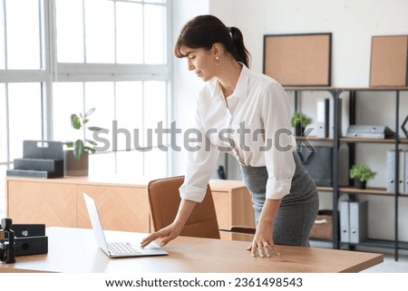 Beautiful businesswoman working with laptop in office