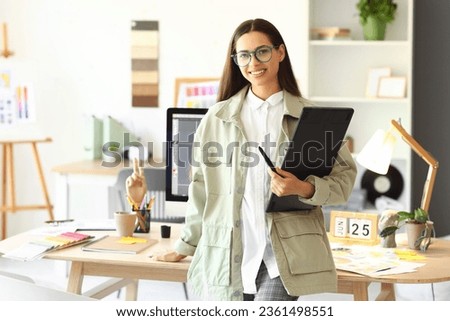 Female interior designer with graphic tablet in office