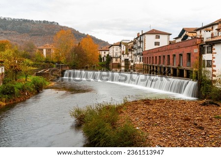 Small dam in a village in northern Spain on a rainy and gray day. Elizondo, Navarra.