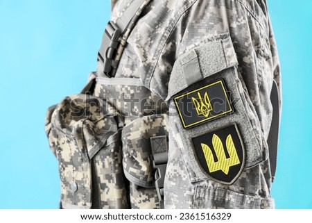 Soldier with Ukrainian chevrons on blue background