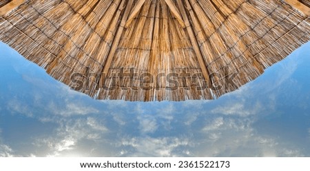 Straw umbrella against the sky. There is a place for photos.