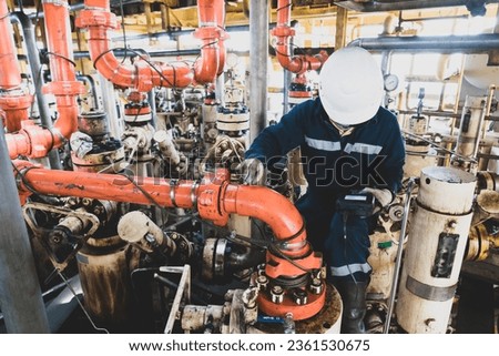 Non-destructive testing technicians are checking the thickness of elbow tubes using ultrasound (UT) testing methods, ultrasound testing to determine the residual thickness after use. Royalty-Free Stock Photo #2361530675