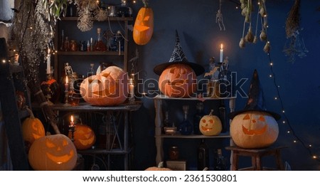 Halloween pumpkins with lights and  burning  candles and magic potions in witch's house Royalty-Free Stock Photo #2361530801