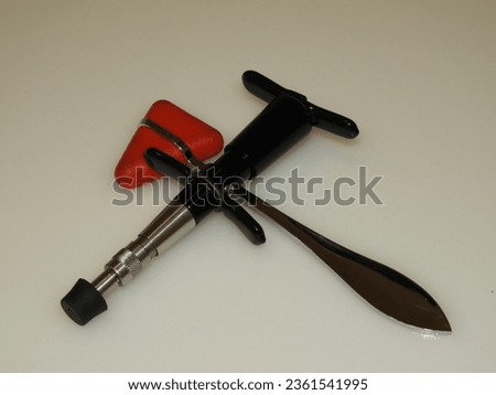 Chiropractic adjustment tool with red reflex hammer Royalty-Free Stock Photo #2361541995