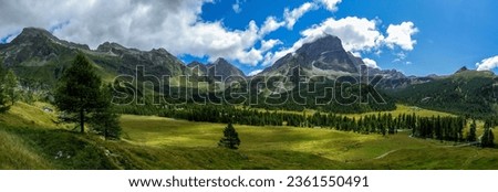 Panorama of a beautiful mountain valley. Mountain panoramic landscape. Beautiful mountain panorama. Mountain panorama in Alps Royalty-Free Stock Photo #2361550491