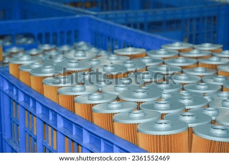 Oil fliters in plastic turnover box. Auto spare parts.  Royalty-Free Stock Photo #2361552469