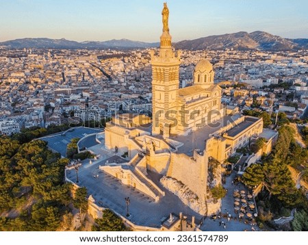 A bird's eye view. Notre Dame de la Garde or Our Lady of the Guard aerial view, it is a catholic church in Marseille city in France. View from a flying drone of old town. Top view Royalty-Free Stock Photo #2361574789