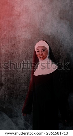 Scary devil nun standing with dark wall background. Scary woman for Halloween. Halloween concept