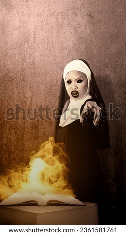 A scary devil nun standing with a burned book with a dark wall background. Scary woman for Halloween. Halloween concept
