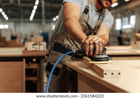 Close up of carpenter hands sanding wood with orbital sander at workshop Royalty-Free Stock Photo #2361584223
