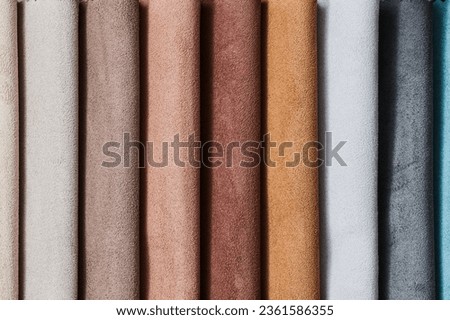 Colorful samples of upholstery fabrics close-up. Leather and suede for furniture renovation Royalty-Free Stock Photo #2361586355