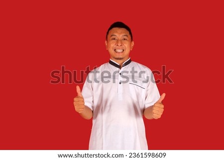 Mature Asian man wearing white shirt giving two thumbs up
