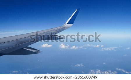 Airplane wing on a background of blue sky flight time