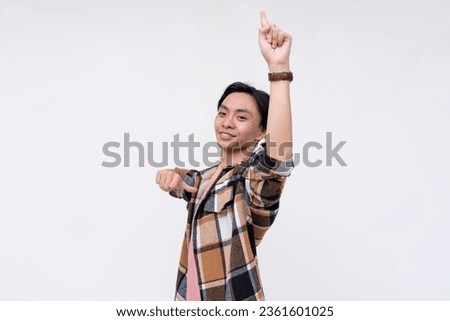 A overconfident and egotistical young man points up to the sky and himself and proclaiming himself to be number 1. Isolated on a white background. Royalty-Free Stock Photo #2361601025
