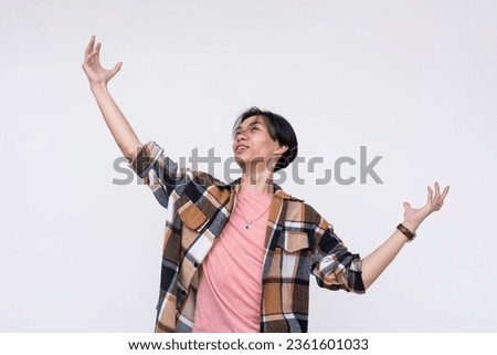 A overconfident and egotistical young man looking up and proclaiming himself to be the best in the world. Isolated on a white background. Royalty-Free Stock Photo #2361601033