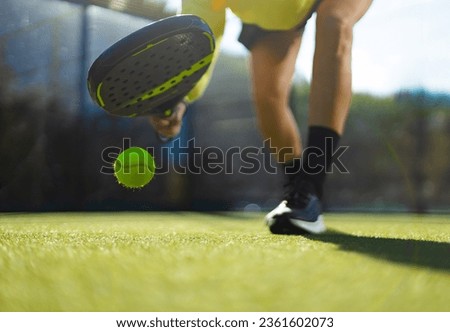 Close-up photo. Padel tennis player with racket. Girl athlete with paddle racket on court outdoors. Sport concept. Download a high quality photo for the design of a sports app or web site.