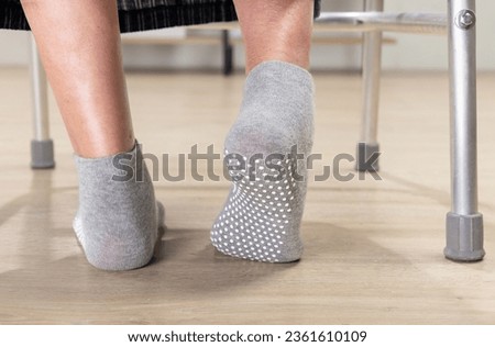 Elderly woman wear non slip grip socks for senior people who have trouble keeping their balance. Royalty-Free Stock Photo #2361610109